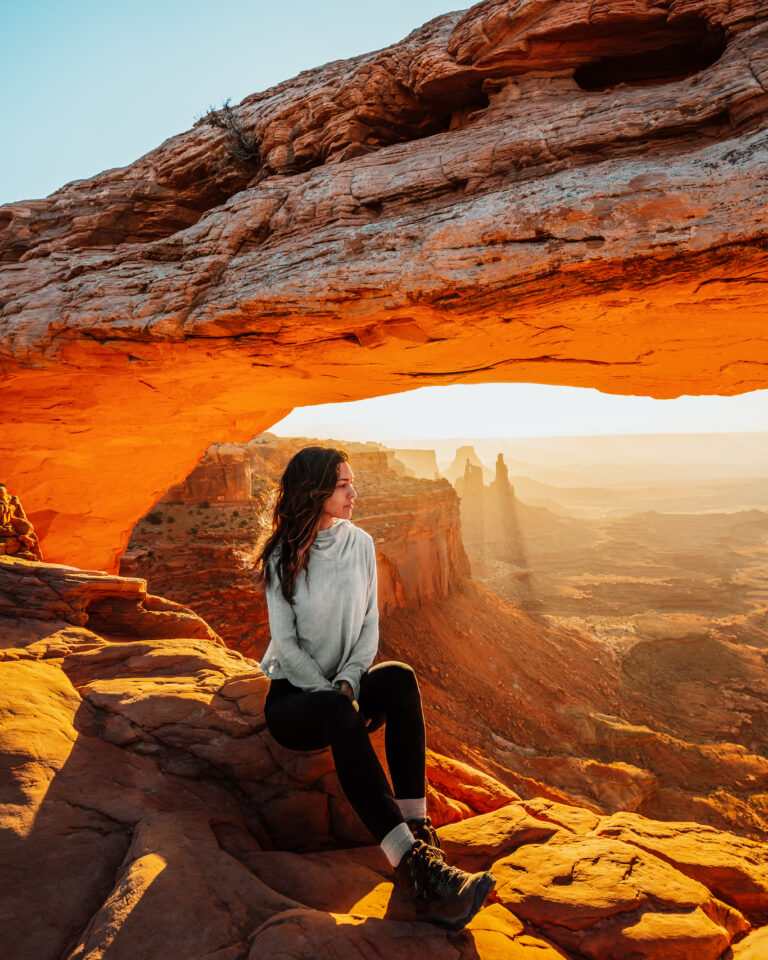 Bree sits on a rock at Arches National Park, Utah