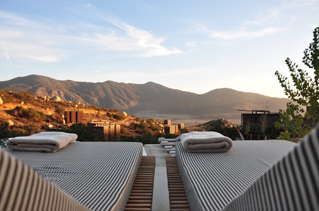 2 striped lounger beach chairs overlook the himalayan mountains