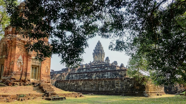 a view of the Angkor Wat temple through the trees